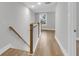Hallway with hardwood floors, white trim, and natural light from window at 1153 Oak Bluff Ave, Charleston, SC 29492