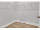 Walk-in closet with wood-look flooring, shelving, and ample storage space at 1153 Oak Bluff Ave, Charleston, SC 29492