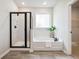 Bright bathroom featuring a walk-in shower, soaker tub with a modern fixture, window, and neutral tones at 3000 Winding Grove Ln, Moncks Corner, SC 29461