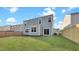 Backyard view features a well-maintained lawn, wooden fence, and a light blue house at 220 Maple Hill Dr, Moncks Corner, SC 29461