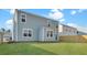 Backyard view features a well-maintained lawn, wooden fence, and a light blue house at 220 Maple Hill Dr, Moncks Corner, SC 29461