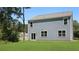 Home backyard featuring lush green lawn and light blue siding with door and windows at 127 Morning View Way, Moncks Corner, SC 29461