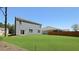 Backyard featuring a lush green lawn and light blue siding with door and windows at 127 Morning View Way, Moncks Corner, SC 29461