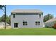 Home backyard featuring lush green lawn and light blue siding with door and windows at 127 Morning View Way, Moncks Corner, SC 29461