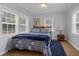 Bedroom with blue and white bedding and wood floors at 8375 Shell House Rd, Edisto Island, SC 29438