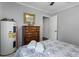 Bedroom with double bed, dresser, and water heater at 8375 Shell House Rd, Edisto Island, SC 29438