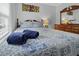 Well-lit bedroom with full bed and mirrored dresser at 8375 Shell House Rd, Edisto Island, SC 29438