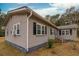 Exterior view of the home, highlighting gray siding and black shutters at 8375 Shell House Rd, Edisto Island, SC 29438