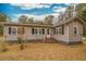 Ranch style home with brick steps, grey siding, and black shutters at 8375 Shell House Rd, Edisto Island, SC 29438