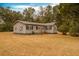 House exterior showcasing gray siding and black shutters at 8375 Shell House Rd, Edisto Island, SC 29438