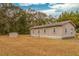 Tan house with white trim, satellite dish, and storage shed in backyard at 8375 Shell House Rd, Edisto Island, SC 29438