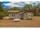 Tan house with white trim, satellite dish, and propane tank at 8375 Shell House Rd, Edisto Island, SC 29438