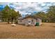 Tan house with white trim, satellite dish, and propane tank at 8375 Shell House Rd, Edisto Island, SC 29438