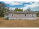 Tan house with white trim, satellite dish, and storage shed in backyard at 8375 Shell House Rd, Edisto Island, SC 29438