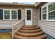 Side entrance with brick steps and white door at 8375 Shell House Rd, Edisto Island, SC 29438