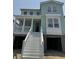 Charming two-story home with a covered porch, white trim, and a two-car garage, under construction at 1157 Oak Bluff Ave, Charleston, SC 29492