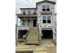 Exterior view of a new construction home, featuring a multi-story design with a covered porch and an attached garage at 1157 Oak Bluff Ave, Charleston, SC 29492