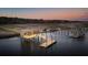 Elevated view of a waterfront home with private dock and surrounding landscape at 633 Barbados Dr, Charleston, SC 29492