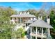 Large estate home with multiple levels and balconies, nestled in trees at 633 Barbados Dr, Charleston, SC 29492