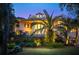 House with large windows, a stone retaining wall, and palm trees in the backyard at 633 Barbados Dr, Charleston, SC 29492