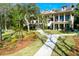 Landscaped backyard with home, stone walkway and lush greenery at 633 Barbados Dr, Charleston, SC 29492