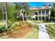 Landscaped backyard with home, stone walkway and lush greenery at 633 Barbados Dr, Charleston, SC 29492