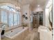 Spa-like bathroom featuring a soaking tub, walk-in shower, and large window at 633 Barbados Dr, Charleston, SC 29492