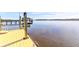 Yellow wooden dock extending over calm water towards other docks and houses at 633 Barbados Dr, Charleston, SC 29492