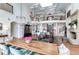Open concept dining room with long wooden table and chandelier at 633 Barbados Dr, Charleston, SC 29492