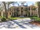 Grand two-story home with columns, lush landscaping, and a long driveway at 633 Barbados Dr, Charleston, SC 29492