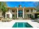 Elegant home with large windows, columns, and a spacious backyard at 633 Barbados Dr, Charleston, SC 29492
