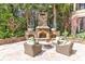Stone fireplace and seating area in a landscaped patio at 633 Barbados Dr, Charleston, SC 29492