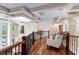 Open-concept upper hallway with seating area and hardwood floors at 633 Barbados Dr, Charleston, SC 29492