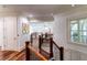 Elegant hardwood hallway with a stunning staircase and natural light at 633 Barbados Dr, Charleston, SC 29492