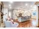 Spacious kitchen with island seating, stone fireplace, and hardwood floors at 633 Barbados Dr, Charleston, SC 29492