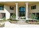 Elegant stone patio with seating area, columns, and lush landscaping at 633 Barbados Dr, Charleston, SC 29492