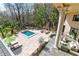 Expansive pool area with patio, outdoor fireplace, and lush landscaping at 633 Barbados Dr, Charleston, SC 29492