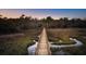 Long wooden bridge extending over marshland leading to a house in the distance at 633 Barbados Dr, Charleston, SC 29492