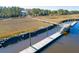 Aerial view of a private dock extending into calm waters, showcasing the waterfront property's serene and accessible location at 1556 John Fenwick Ln, Johns Island, SC 29455