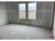 Spacious bedroom featuring two large windows offering natural light and scenic views at 1556 John Fenwick Ln, Johns Island, SC 29455