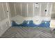Herringbone wood-look tile flooring complements a utility wall with plumbing at 1556 John Fenwick Ln, Johns Island, SC 29455