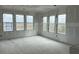 Bright living room with natural light streaming through multiple large windows at 1556 John Fenwick Ln, Johns Island, SC 29455