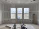 New construction, a living room with three large windows and a scenic view at 1556 John Fenwick Ln, Johns Island, SC 29455