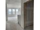 Spacious living room with multiple windows showing backyard views, plaster on walls and ceilings, ready for finishing at 1556 John Fenwick Ln, Johns Island, SC 29455