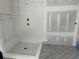 Walk-in shower with white tile and pebble floor at 1556 John Fenwick Ln, Johns Island, SC 29455