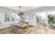 Bright dining room with hardwood floors and access to a deck at 3806 Cameron Blvd, Isle of Palms, SC 29451