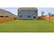 Spacious backyard featuring a pristine lawn, a privacy fence, and a well-maintained home exterior at 142 Morning View Way, Moncks Corner, SC 29461