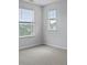 A bedroom features neutral walls, carpeted floors, and two windows at 142 Morning View Way, Moncks Corner, SC 29461
