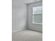 A bedroom features neutral walls, carpeted floors, and a window providing natural light at 142 Morning View Way, Moncks Corner, SC 29461