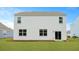 Backyard featuring a well-maintained lawn and a sliding glass door leading to the home's interior at 148 Morning View Way, Moncks Corner, SC 29461